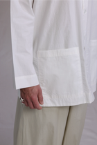 ALBI Sei Shirt, a long oversized cotton poplin band collar shirt with low patch pockets