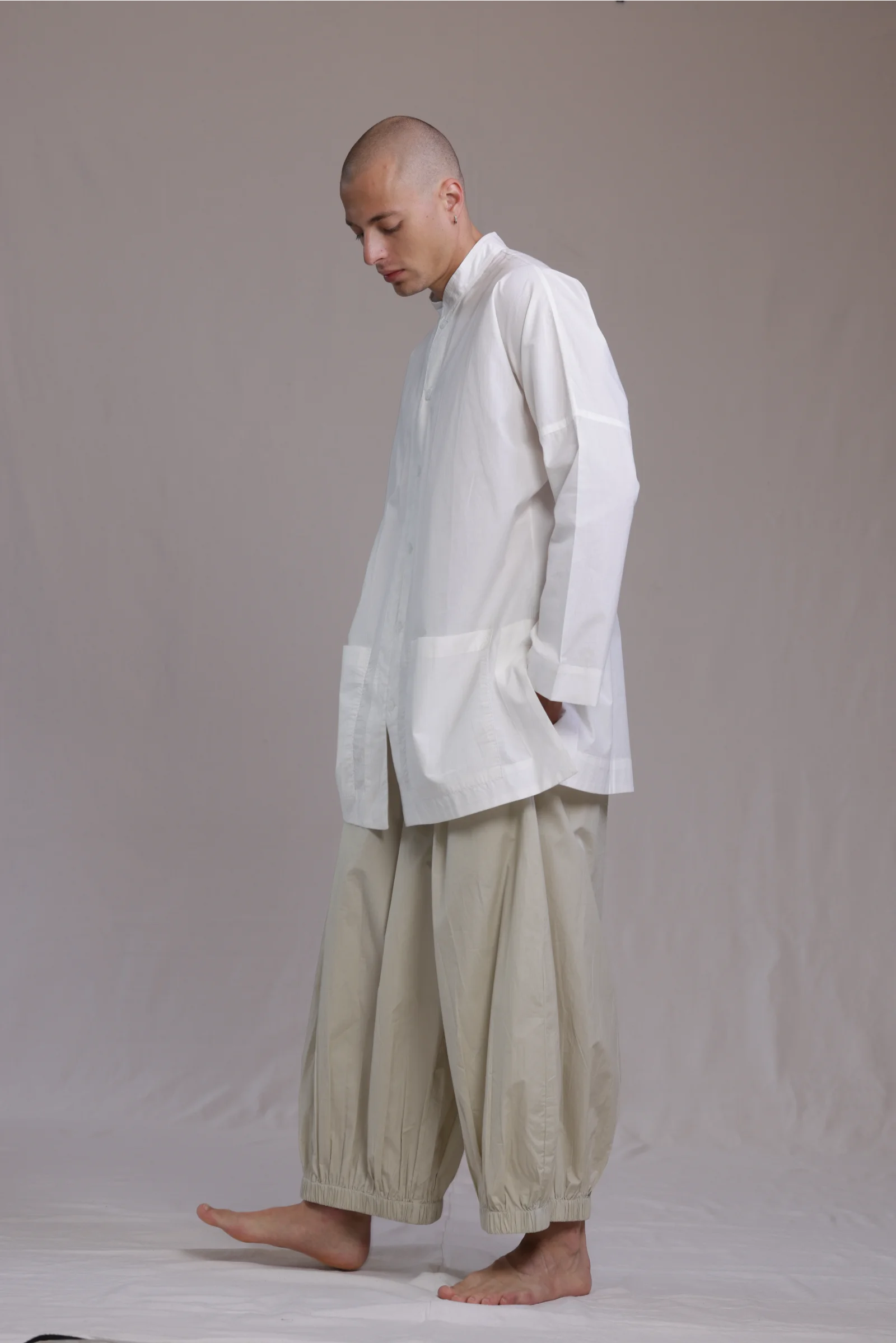 ALBI Sei Shirt, a long oversized cotton poplin band collar shirt with low patch pockets